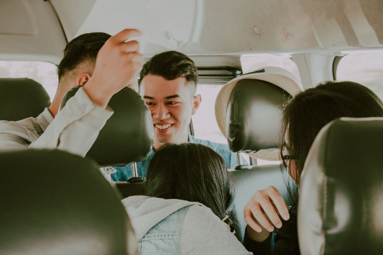 Friends laughing together on a car ride, on the way to somewhere good.